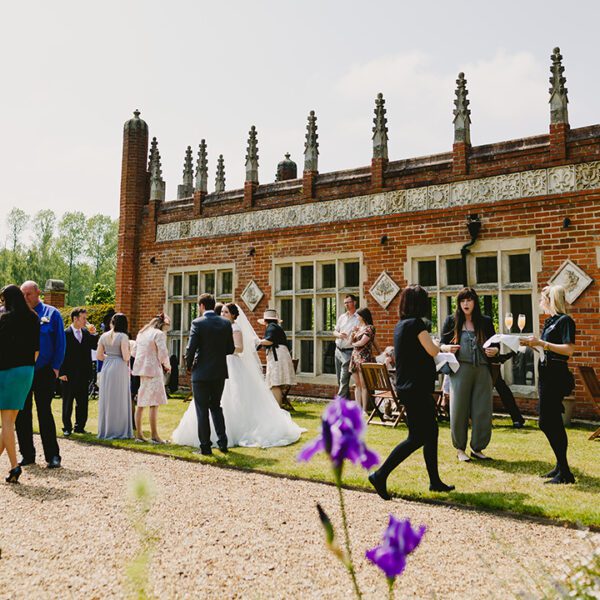 The happy couple and their guests enjoy mingling in the gardens by the orangery at Oxnead Hall
